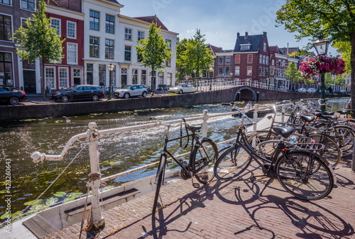 Bunch of bicycles standing by canal in Leiden, the Netherlands