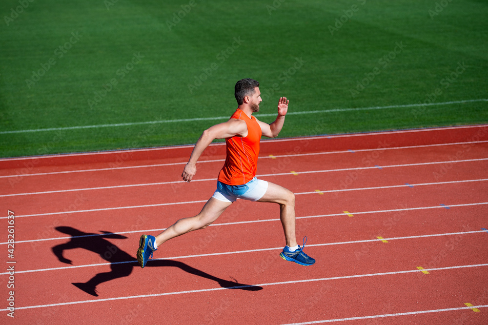 sportsman man in sportswear run fast sprinting on running track, energy sportsman man in sportswear run fast sprinting on running track, energy
