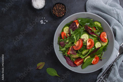 Healthy fresh salad of vegetable cucumber, tomato, spinach, arugula