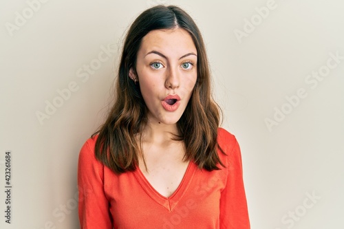 Young brunette woman wearing casual clothes afraid and shocked with surprise expression, fear and excited face.