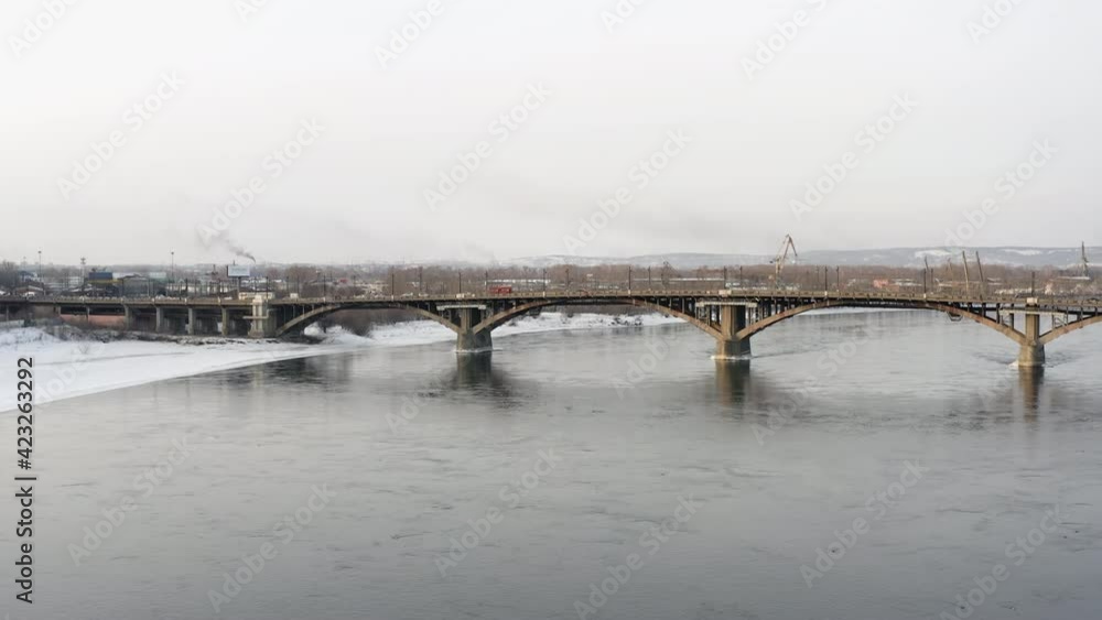 Drone flight aerial photography along the Angara river towards Glazkovsky bridge in winter, Irkutsk. Fly forward, straight ahead Drone flight aerial photography along the Angara river towards Glazkovsky bridge in winter, Irkutsk. Fly forward, straight ahead