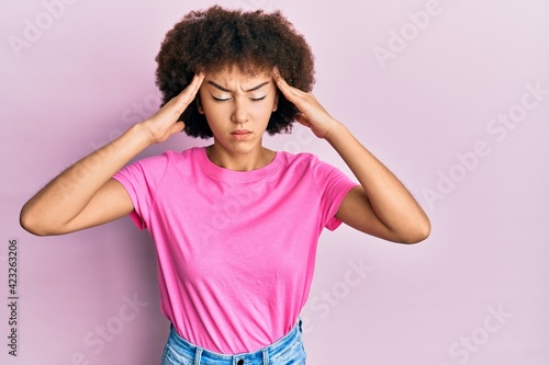 Young hispanic girl wearing casual clothes with hand on head  headache because stress. suffering migraine.