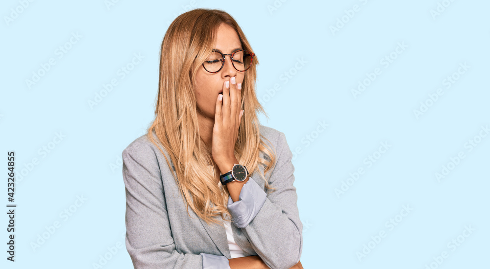 Beautiful blonde young woman wearing business clothes bored yawning tired covering mouth with hand. restless and sleepiness. Beautiful blonde young woman wearing business clothes bored yawning tired covering mouth with hand. restless and sleepiness.