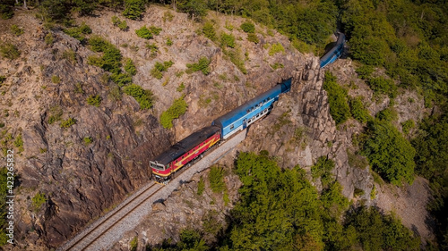 Through the Sazava Valley. The train, Posazavsky Pacifik, rolls around the pinnacle Pikovska Jehla photo