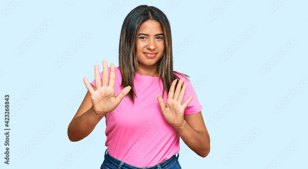 Young latin girl wearing casual clothes disgusted expression, displeased and fearful doing disgust face because aversion reaction. with hands raised Young latin girl wearing casual clothes disgusted expression, displeased and fearful doing disgust face because aversion reaction. with hands raised