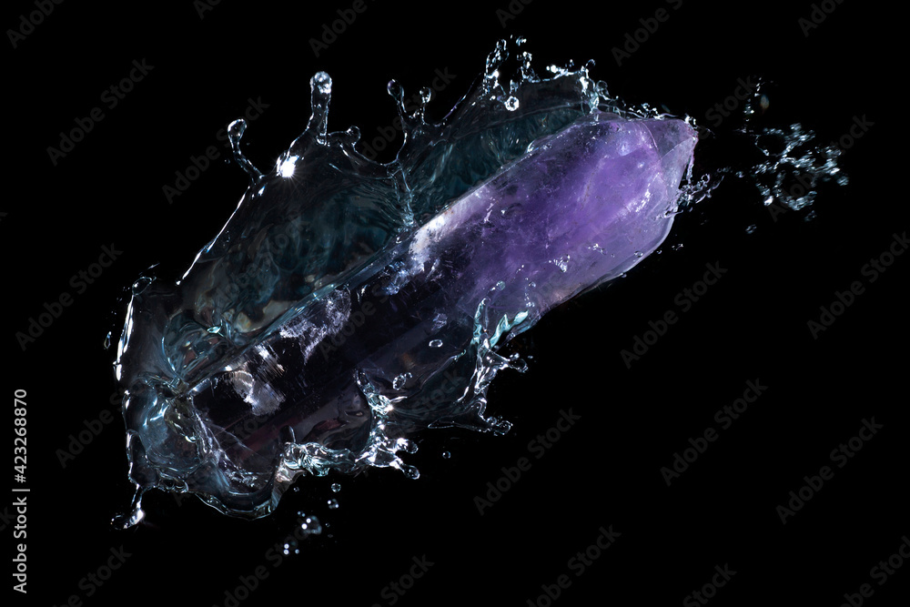 Purple quartz crystal falling into water