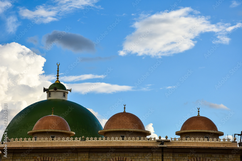 Beautiful cotton clouds behind mosque dome
