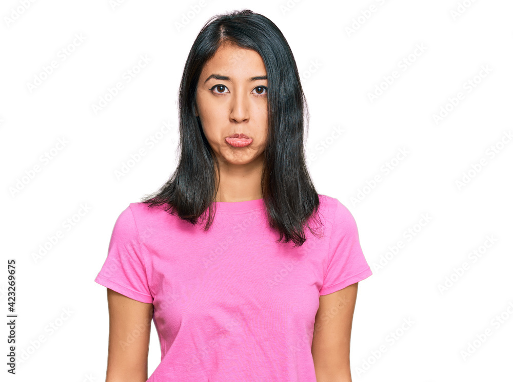 Beautiful asian young woman wearing casual pink t shirt depressed and worry for distress, crying angry and afraid. sad expression. Beautiful asian young woman wearing casual pink t shirt depressed and worry for distress, crying angry and afraid. sad expression.