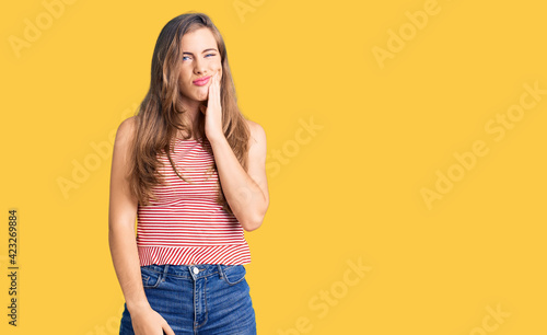 Beautiful caucasian young woman wearing casual clothes touching mouth with hand with painful expression because of toothache or dental illness on teeth. dentist