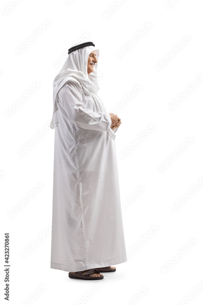 Full length profile shot of a mature arab man in white dishdasha