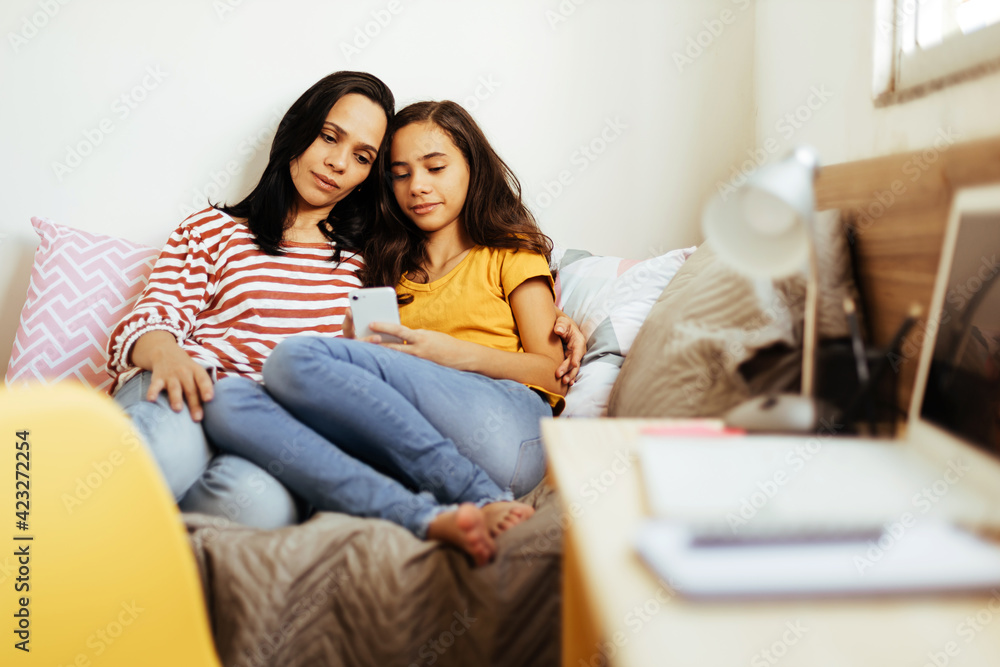 Single parenthood. Mother and daughter spending time together at home.