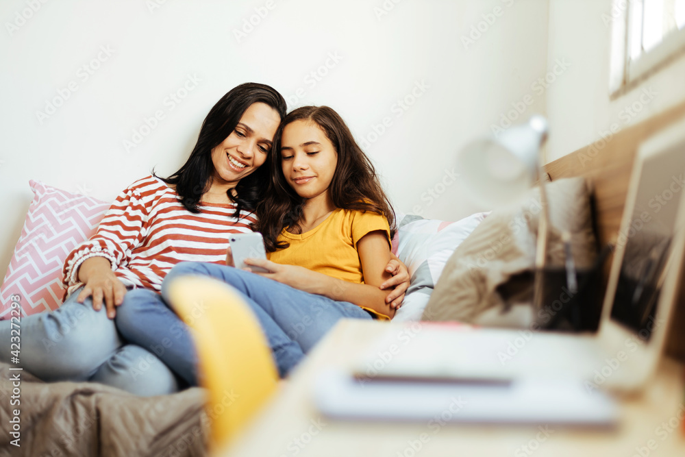 Single parenthood. Mother and daughter spending time together at home. Single parenthood. Mother and daughter spending time together at home.