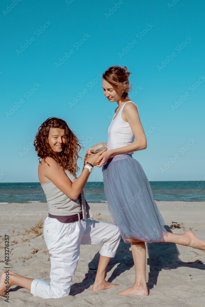 Woman Proposing To Her Happy Girlfriend On The Beach Lesbian Couple In Love Engagement In