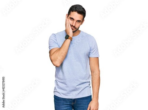 Young hispanic man wearing casual clothes thinking looking tired and bored with depression problems with crossed arms. © Krakenimages.com