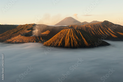 Mount Bromo (large crater, left) at sunrise in Bromo-Tengger-Semeru National Park on the island of Java in Indonesia      photo