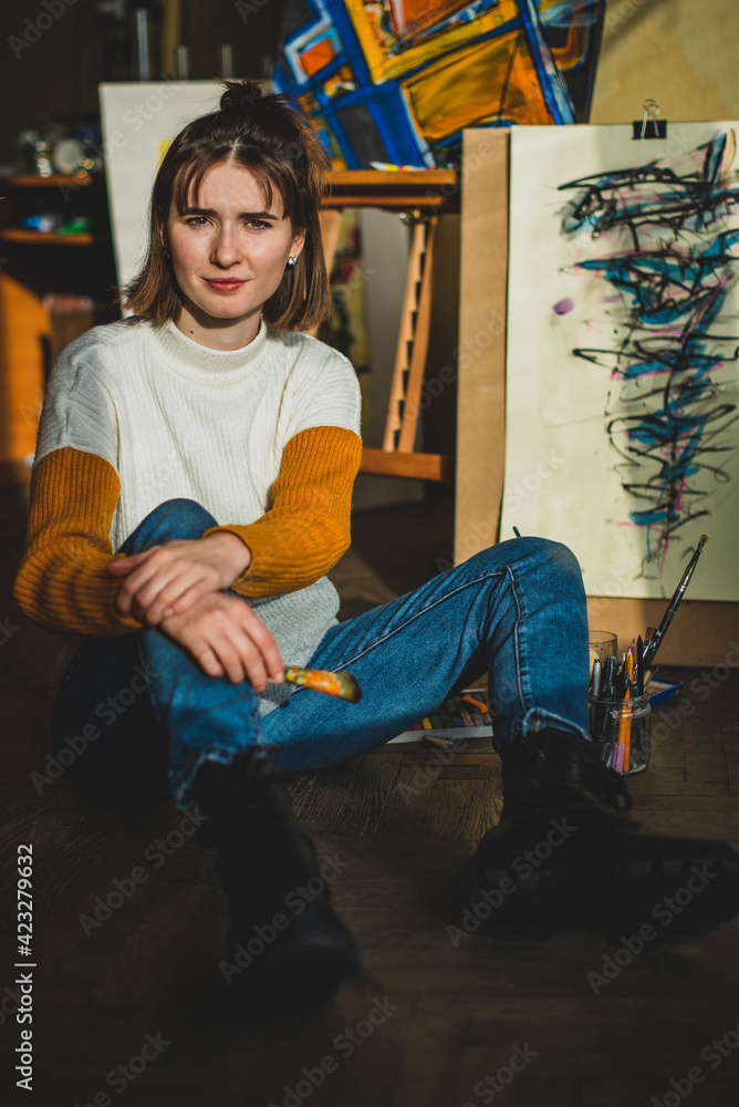 Beautiful woman painting. Girl in Painting Studio. Talented Female Artist Working on a Modern Abstract Oil Painting, Gesturing with Broad Strokes Using Paint Brush. Dark Creative Studio Beautiful woman painting. Girl in Painting Studio. Talented Female Artist Working on a Modern Abstract Oil Painting, Gesturing with Broad Strokes Using Paint Brush. Dark Creative Studio
