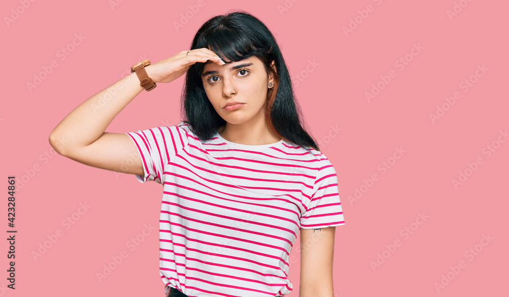 Young hispanic girl wearing casual clothes worried and stressed about a problem with hand on forehead, nervous and anxious for crisis Young hispanic girl wearing casual clothes worried and stressed about a problem with hand on forehead, nervous and anxious for crisis