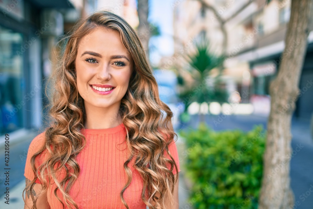 Young blonde girl smiling happy walking at the city. Young blonde girl smiling happy walking at the city.