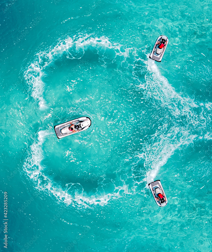 Jet Ski water sport lifestyle. Aerial view clear turquoise sea. Maldives tropical island summer vacation.