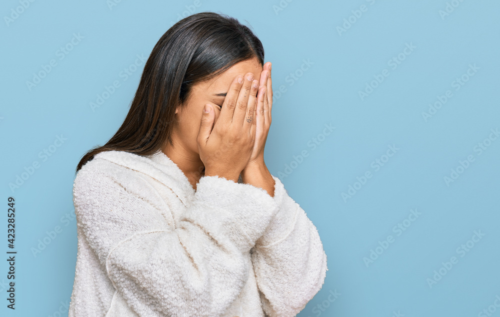 Young brunette woman wearing casual clothes with sad expression covering face with hands while crying. depression concept. Young brunette woman wearing casual clothes with sad expression covering face with hands while crying. depression concept.