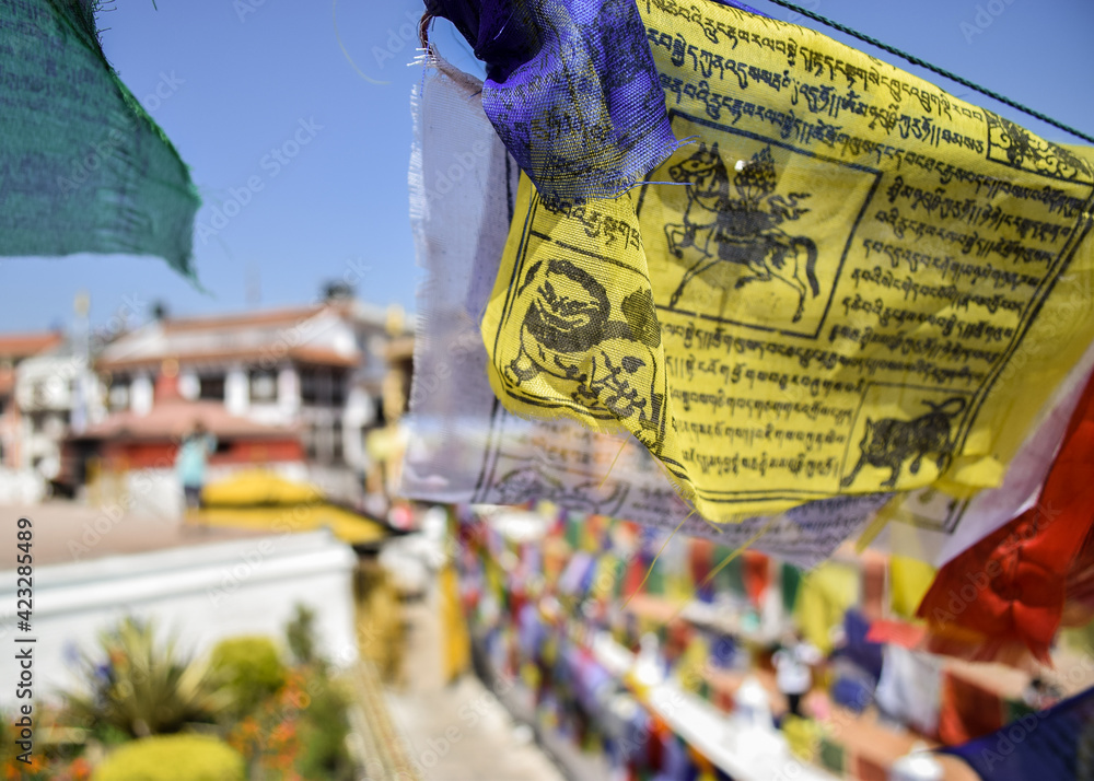Fototapeta premium Close-up of colorful prayer flags hanging on Boudhanath stupa. Shallow depth of field. Kathmandu, Nepal.
