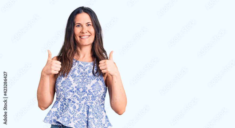 Young beautiful brunette woman wearing casual t-shirt success sign doing positive gesture with hand, thumbs up smiling and happy. cheerful expression and winner gesture. Young beautiful brunette woman wearing casual t-shirt success sign doing positive gesture with hand, thumbs up smiling and happy. cheerful expression and winner gesture.