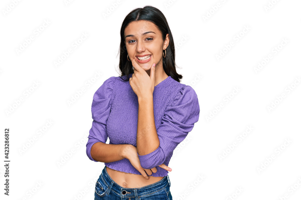 Young hispanic girl wearing casual clothes looking confident at the camera smiling with crossed arms and hand raised on chin. thinking positive. Young hispanic girl wearing casual clothes looking confident at the camera smiling with crossed arms and hand raised on chin. thinking positive.
