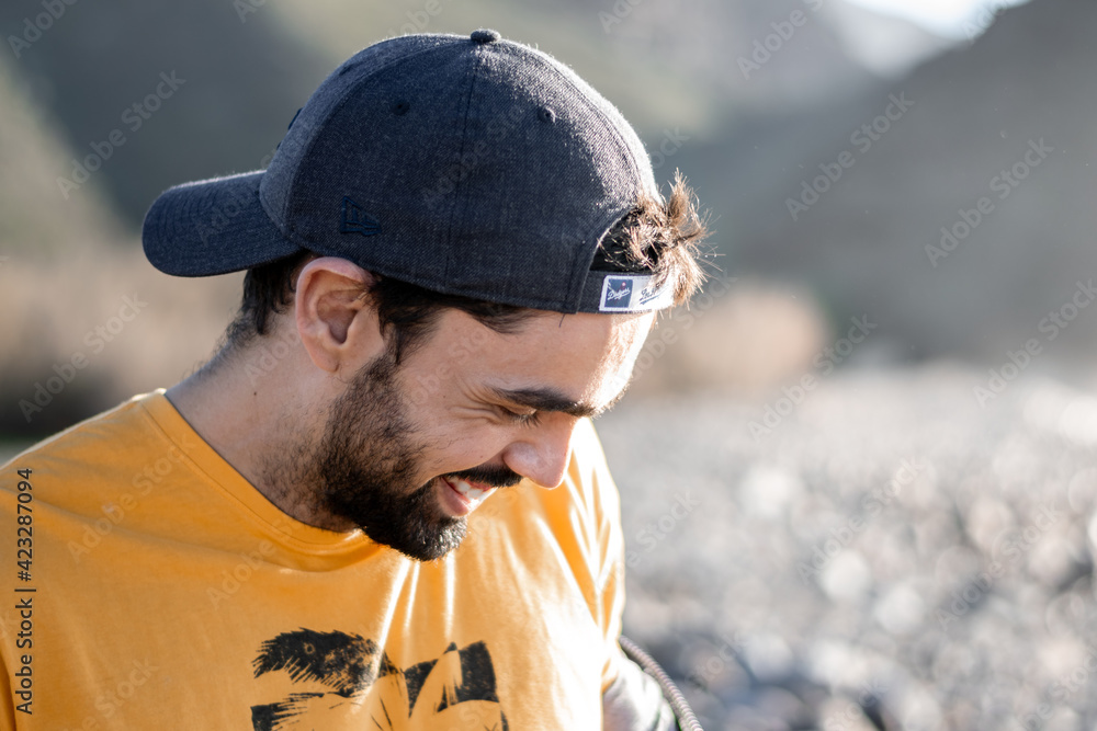 Portrait of young man in profile in nature smiling
Portrait of young man in profile in nature smiling