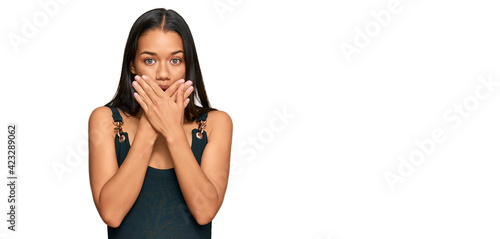 Beautiful hispanic woman wearing casual clothes shocked covering mouth with hands for mistake. secret concept.