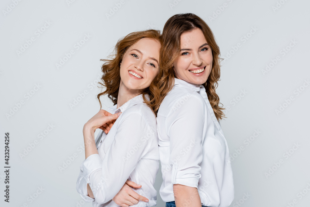 Cheerful adult women looking at camera isolated on grey Cheerful adult women looking at camera isolated on grey