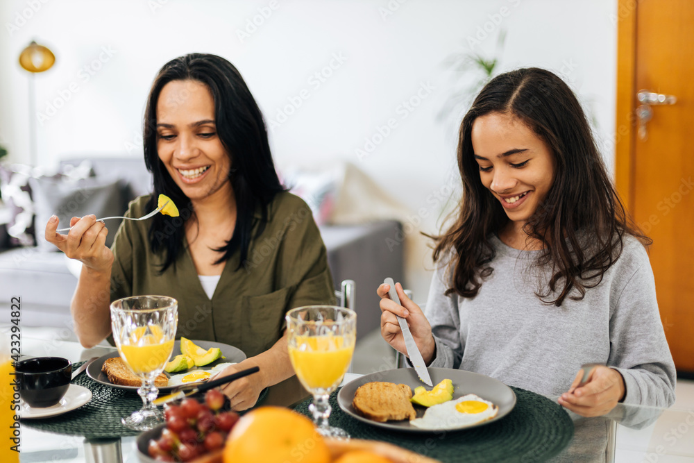 Single Parenthood. Mother and preteen daughter having breakfast at home. Single Parenthood. Mother and preteen daughter having breakfast at home.