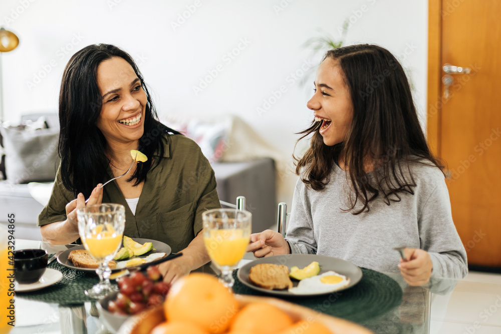 Single Parenthood. Mother and preteen daughter having breakfast at home. Single Parenthood. Mother and preteen daughter having breakfast at home.