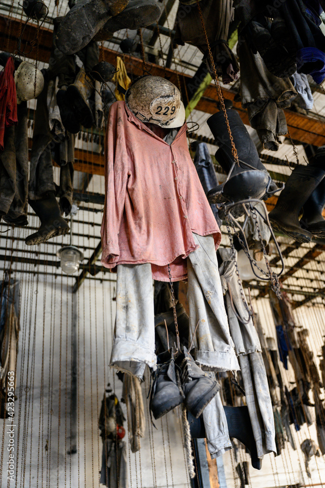 Mining clothes hung in a chain hook locker room.