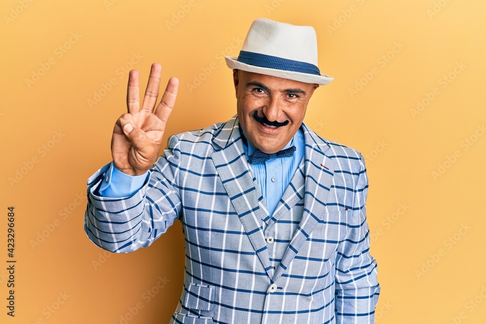 Mature middle east man with mustache wearing vintage and elegant fashion style showing and pointing up with fingers number three while smiling confident and happy.