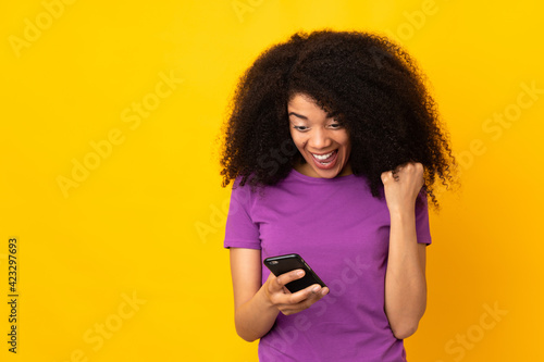 Young african american woman over isolated background surprised and sending a message