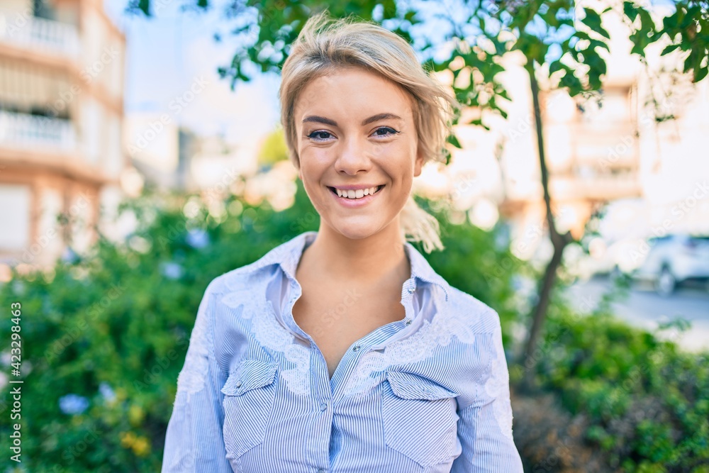 Young blonde woman smiling happy walking at the park. Young blonde woman smiling happy walking at the park.