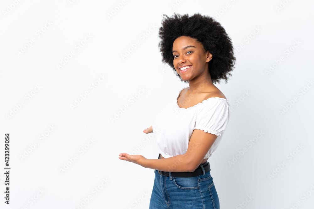 Young African American woman isolated on white background extending hands to the side for inviting to come Young African American woman isolated on white background extending hands to the side for inviting to come