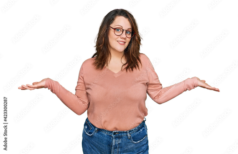 Young plus size woman wearing casual clothes and glasses smiling showing both hands open palms, presenting and advertising comparison and balance Young plus size woman wearing casual clothes and glasses smiling showing both hands open palms, presenting and advertising comparison and balance