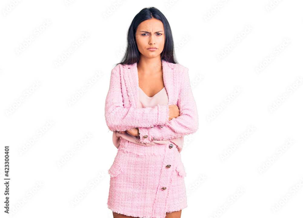 Young beautiful latin girl wearing business clothes skeptic and nervous, disapproving expression on face with crossed arms. negative person. Young beautiful latin girl wearing business clothes skeptic and nervous, disapproving expression on face with crossed arms. negative person.
