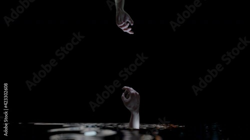 Drowning arm hand reaching out for help and connect with alpha.