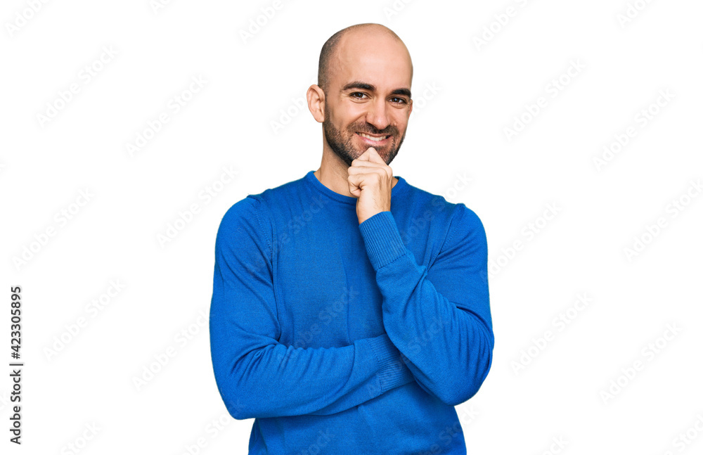 Young hispanic man wearing casual clothes looking confident at the camera with smile with crossed arms and hand raised on chin. thinking positive. Young hispanic man wearing casual clothes looking confident at the camera with smile with crossed arms and hand raised on chin. thinking positive.