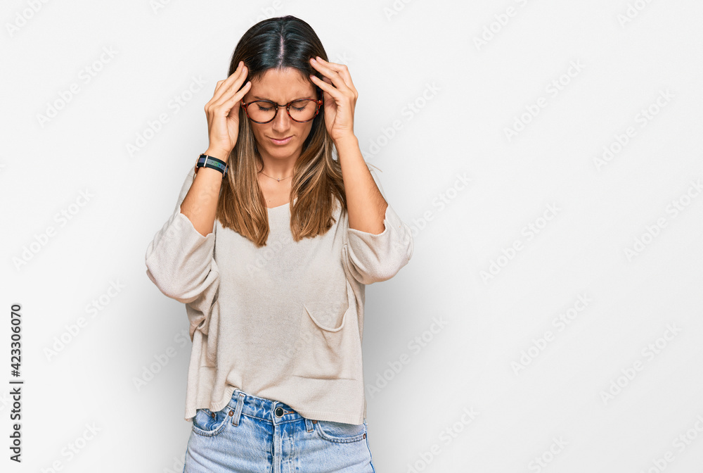 Young woman wearing casual clothes and glasses with hand on head for pain in head because stress. suffering migraine. Young woman wearing casual clothes and glasses with hand on head for pain in head because stress. suffering migraine.