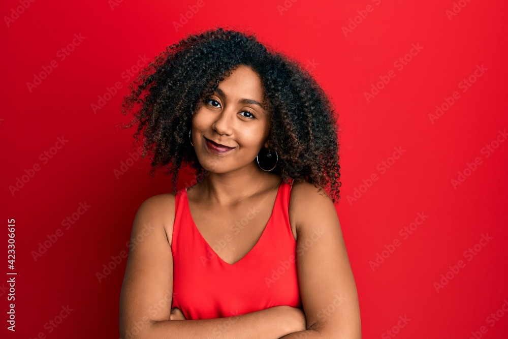 Beautiful african american woman with afro hair wearing casual clothes happy face smiling with crossed arms looking at the camera. positive person. Beautiful african american woman with afro hair wearing casual clothes happy face smiling with crossed arms looking at the camera. positive person.