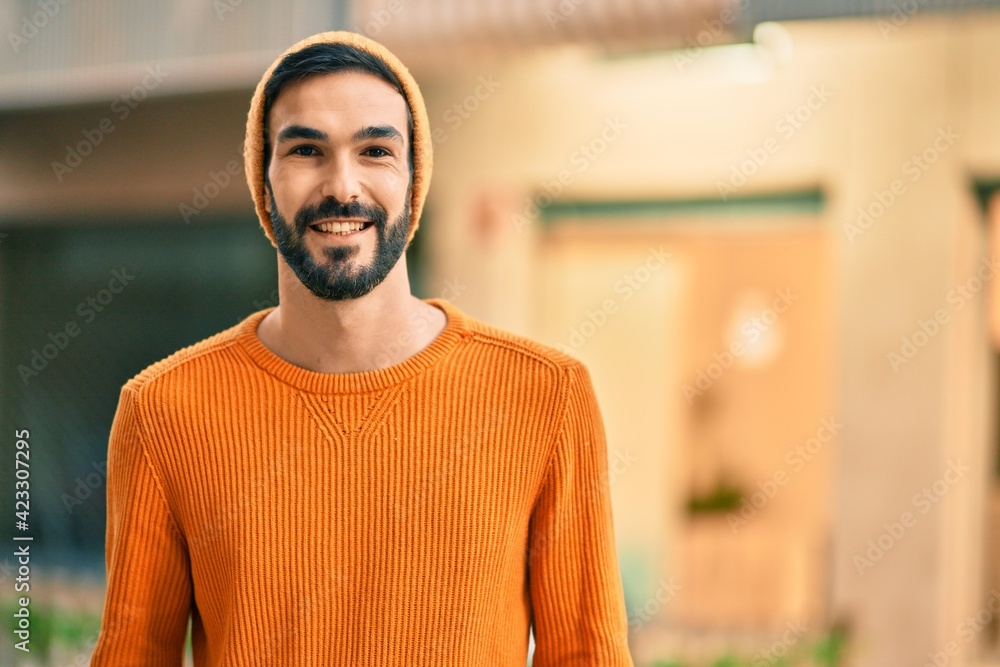 Young hispanic man wearing winter style smiling happy at the city. Young hispanic man wearing winter style smiling happy at the city.
