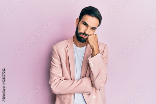 Young hispanic man wearing business jacket thinking looking tired and bored with depression problems with crossed arms.