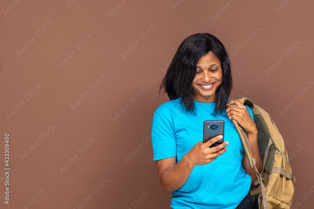 attractive young black student using her phone attractive young black student using her phone