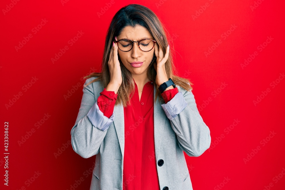 Beautiful brunette woman wearing business shirt and glasses with hand on head, headache because stress. suffering migraine. Beautiful brunette woman wearing business shirt and glasses with hand on head, headache because stress. suffering migraine.