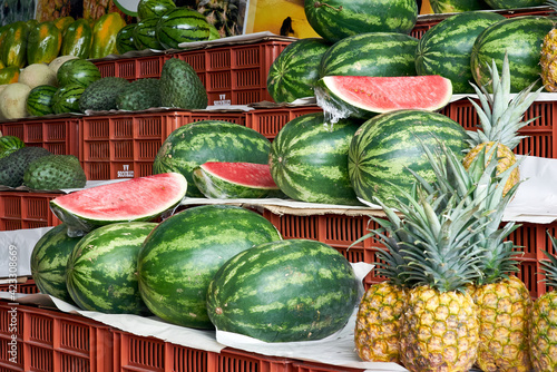Selection of organic watermelons on display at the market stall. Acendría or Síndria. Water melon, scientific name Citrillus Lanatus.