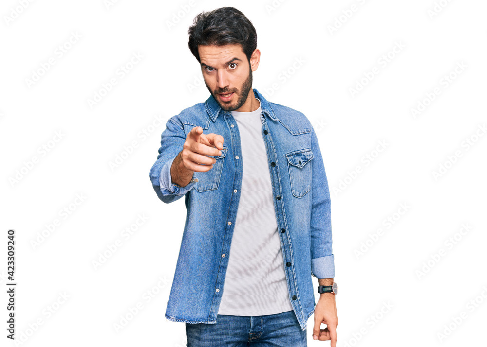 Young hispanic man wearing casual clothes pointing displeased and frustrated to the camera, angry and furious with you Young hispanic man wearing casual clothes pointing displeased and frustrated to the camera, angry and furious with you