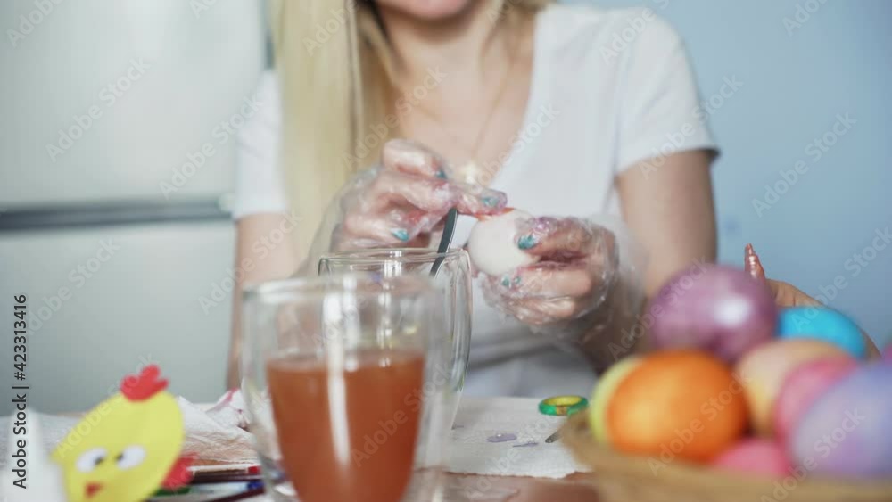 Happy Easter. Preparing the family for Easter. Woman with little girls paints Easter eggs. Happy Easter. Preparing the family for Easter. Woman with little girls paints Easter eggs.